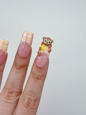 3D monkey press on nails shown worn on hand in square medium