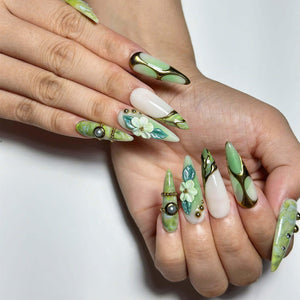 Green marble press on nails with botanical leaf art, 3D white flowers, gold chrome accents, pearl embellishments, and glossy square shape