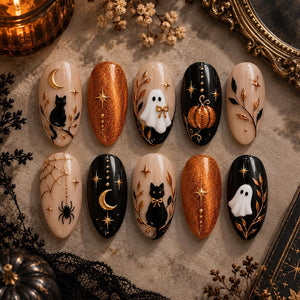 A set of ten almond-shaped press-on nails featuring Halloween designs. The nails display black cats, white ghosts, orange glitter, gold moons, stars, spiders, webs, and pumpkins on black and nude backgrounds with raised gold accents.