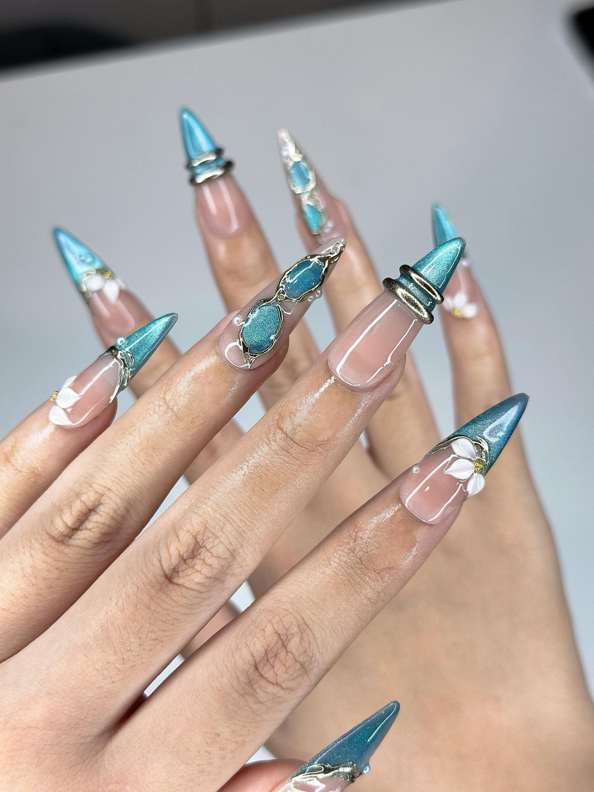 Teal Cat-Eye & 3D White Bloom Nails | Antique Gold Chrome Accents | Luxury Botanical Magnetic Stiletto Art | Elegant Nails | OB379IK