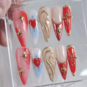 Set of ten false nails with various designs.  The designs include a red heart, a gold swirl, a red cross, and a gold star.  The nails are in a clear plastic box.