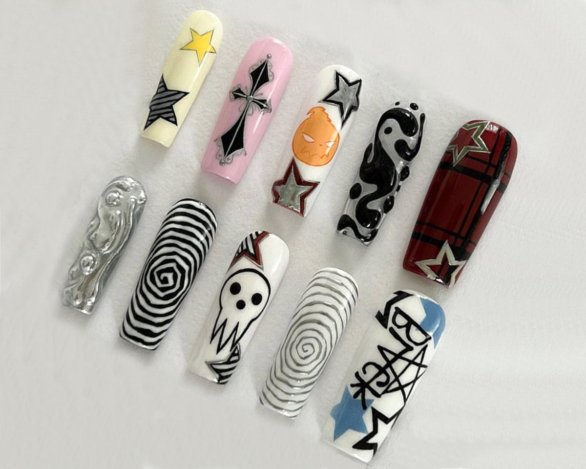 Ten long, white, artificial fingernails with various black and white designs. The designs include a skull, a cross, stars, a yin yang symbol, a spiral, and plaid.
