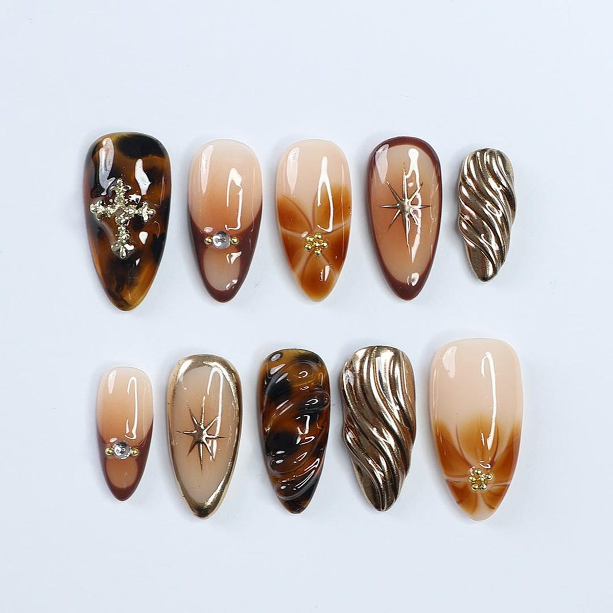 3D tortoise shell fall press on nails with gold starburst accents, nude and brown ombré base, and metallic textured chrome details — handmade custom press on nails, luxury nail art, fake nails, false 