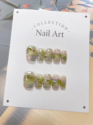 A set of ten fake nails with a light green and pink water lily design. The nails are displayed on a white card with the text "COLLECTION Nail Art".