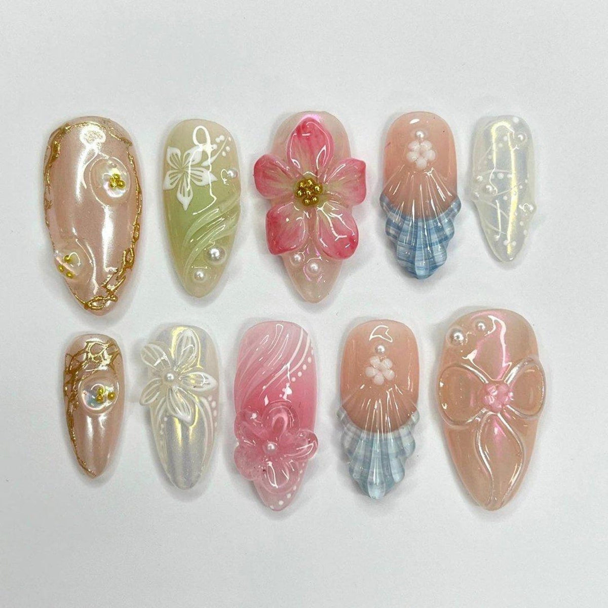 3D summer press on nails with pastel pink, green, and blue floral designs, embellished with pearls and sculpted bows — custom press on nails, luxury handmade nail art, fake nails, false nails, presson