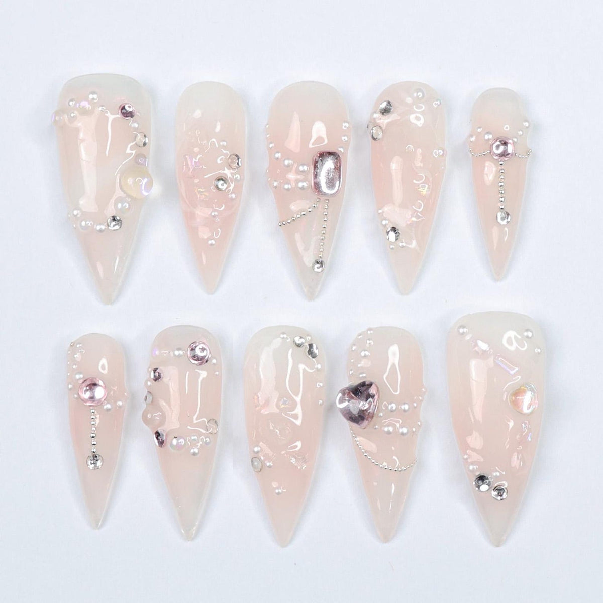 Dazzle in pure elegance with Lustreva, a stunning press-on nail set inspired by the allure of shimmering crystals and delicate silver chains. Handcrafted with iridescent gems, sparkling pearls, and so