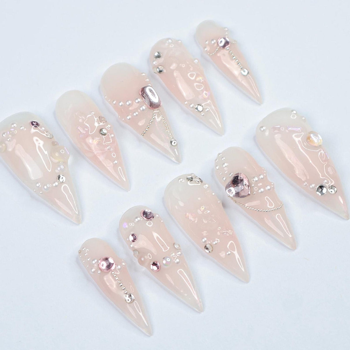 Dazzle in pure elegance with Lustreva, a stunning press-on nail set inspired by the allure of shimmering crystals and delicate silver chains. Handcrafted with iridescent gems, sparkling pearls, and so