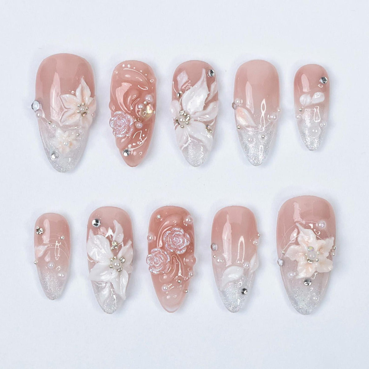 3D bridal press on nails with nude pink base, sculpted white florals, glittery silver ombré tips, and rhinestone accents — luxury wedding nails for bride, custom handmade fake nails, elegant and timel