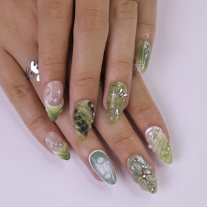 Handmade green press-on nails featuring 3D floral accents, metallic butterflies, and marble effects — perfect for spring events, garden parties, or a thoughtful gift for her.