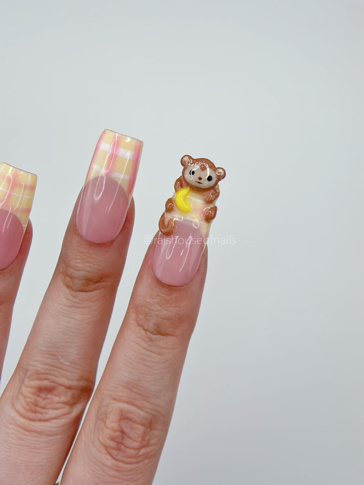 3D monkey press on nails shown worn on hand in square medium