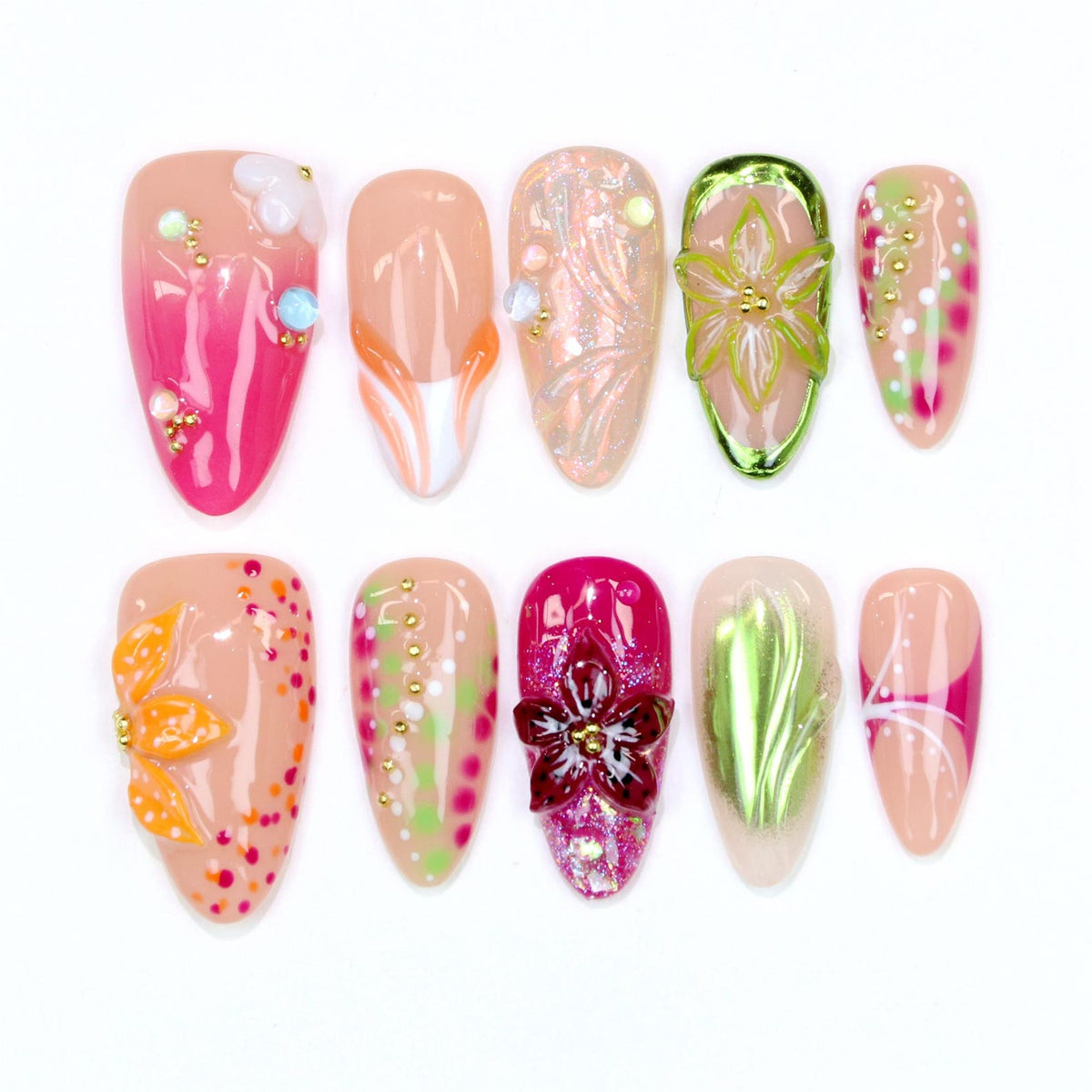 A collection of ten artificial nails in various designs. The nails feature a range of colors, including pink, orange, green, and nude, with floral and abstract patterns. Some nails have 3D embellishments like flowers and beads.