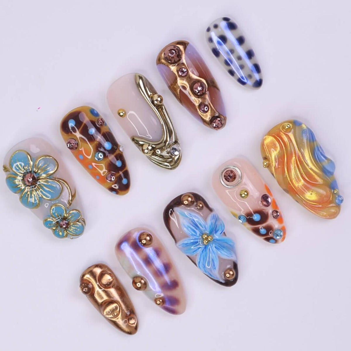 3D blue press on nails with bronze chrome details in a medium almond shape, handmade metallic nail art — perfect for summer vacations, parties, or Y2K looks