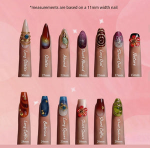 A display of fourteen artificial nail tips in various shapes and lengths, labeled Long Stiletto 30mm, Stiletto 27mm, Almond 22mm, Short Almond 18mm, Long Oval 22mm, Short Oval 17mm, Nature 15mm, Long Coffin 28mm, Ballerina 24mm, Long Square 23mm, Sho