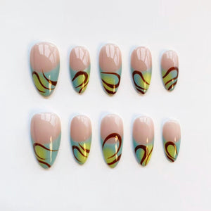 A set of ten oval-shaped false nails. Each nail features a light pink base, a turquoise and yellow gradient, and a dark brown swirl design. The nails are arranged in two rows of five.