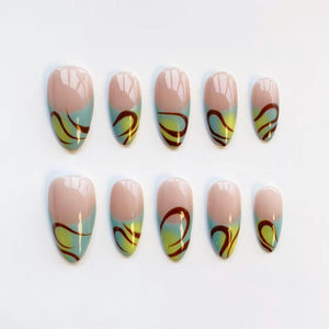 A set of ten oval-shaped false nails. Each nail features a light pink base, a gradient of light blue and yellow, and a dark brown swirl design. The nails are arranged on a white surface.