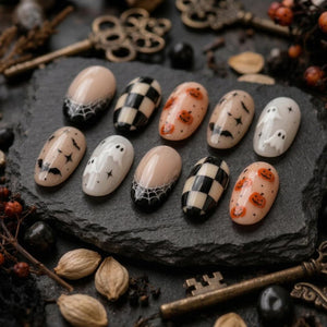 A set of ten oval-shaped press-on nails featuring Halloween-themed designs including black and white spiderwebs, a black and white checkerboard pattern, orange jack-o'-lanterns, black bats with stars, and white ghosts on a neutral base.