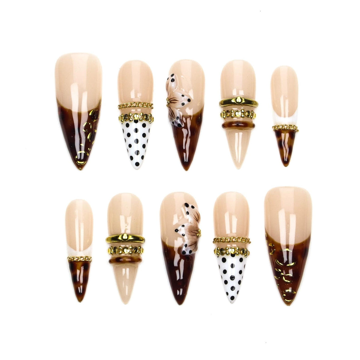 A set of ten stiletto-shaped press-on nails featuring a nude base with various designs including dark brown tortoise shell patterns, black polka dots on white, gold-toned metallic bands, and three-dimensional floral accents.