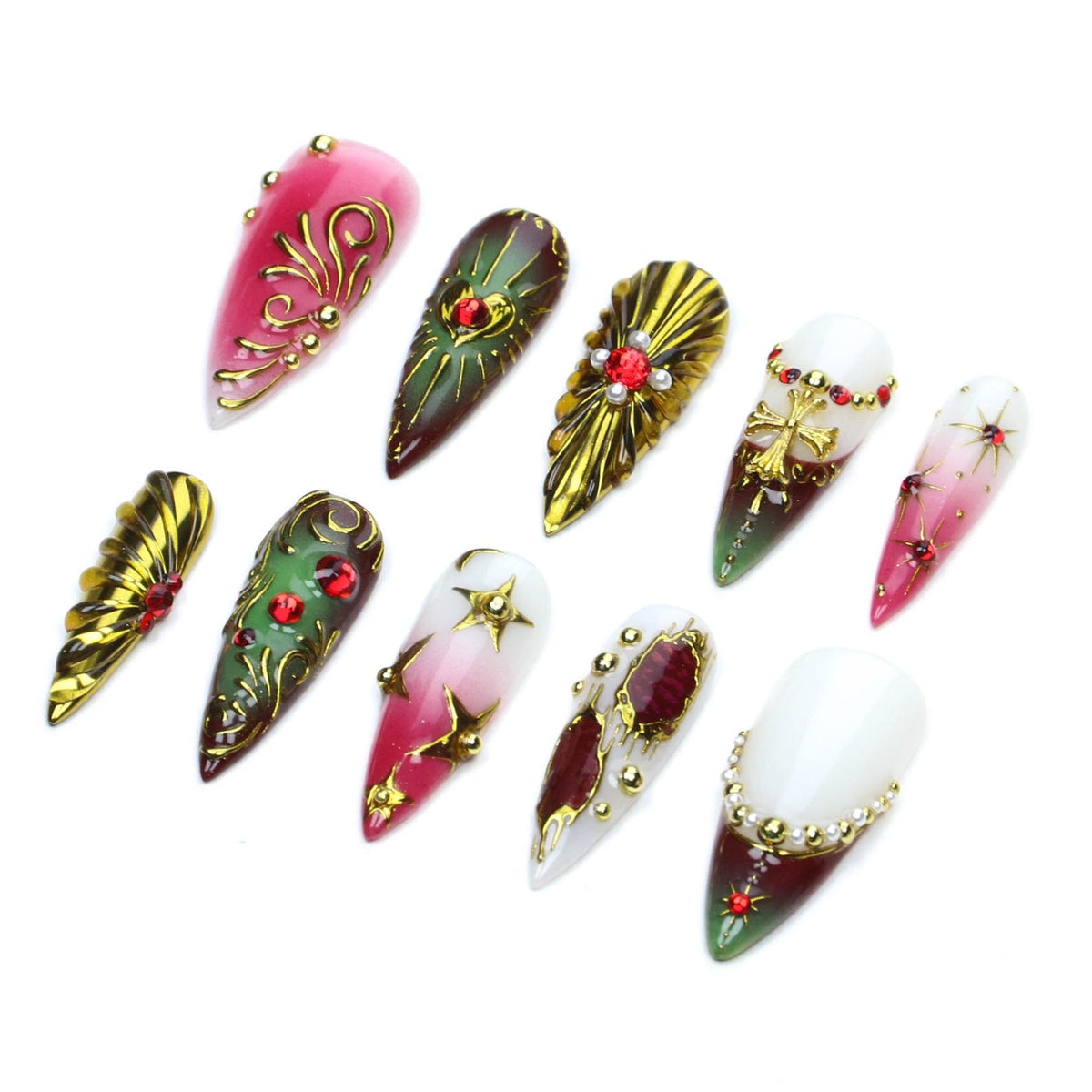 A set of ten stiletto-shaped press-on nails featuring a variety of designs including red, green, and white gradients, metallic gold filigree patterns, embedded red rhinestones, gold cross charms, and small white pearl-like accents.