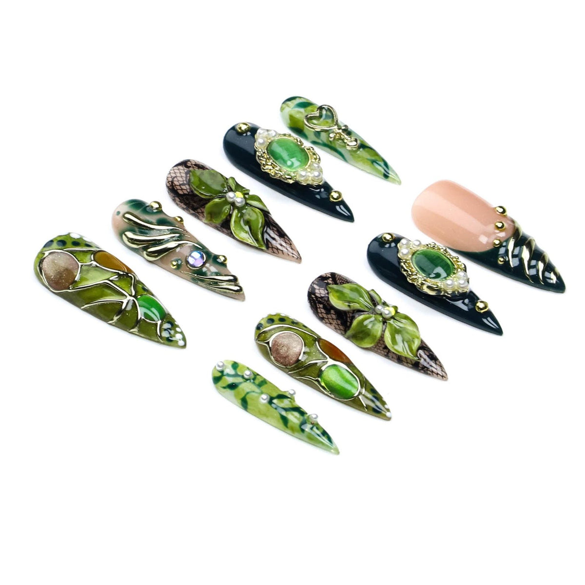 A set of ten stiletto-shaped press-on nails featuring various designs in shades of green, black, and nude. The nails are decorated with three-dimensional floral elements, gold metallic accents, small white pearls, and intricate patterns.
