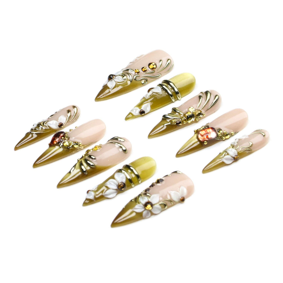 A set of ten stiletto-shaped press-on nails featuring a gradient of nude and olive green tones. The nails are decorated with three-dimensional white floral accents, gold metallic swirls, and small embedded amber-colored rhinestones.