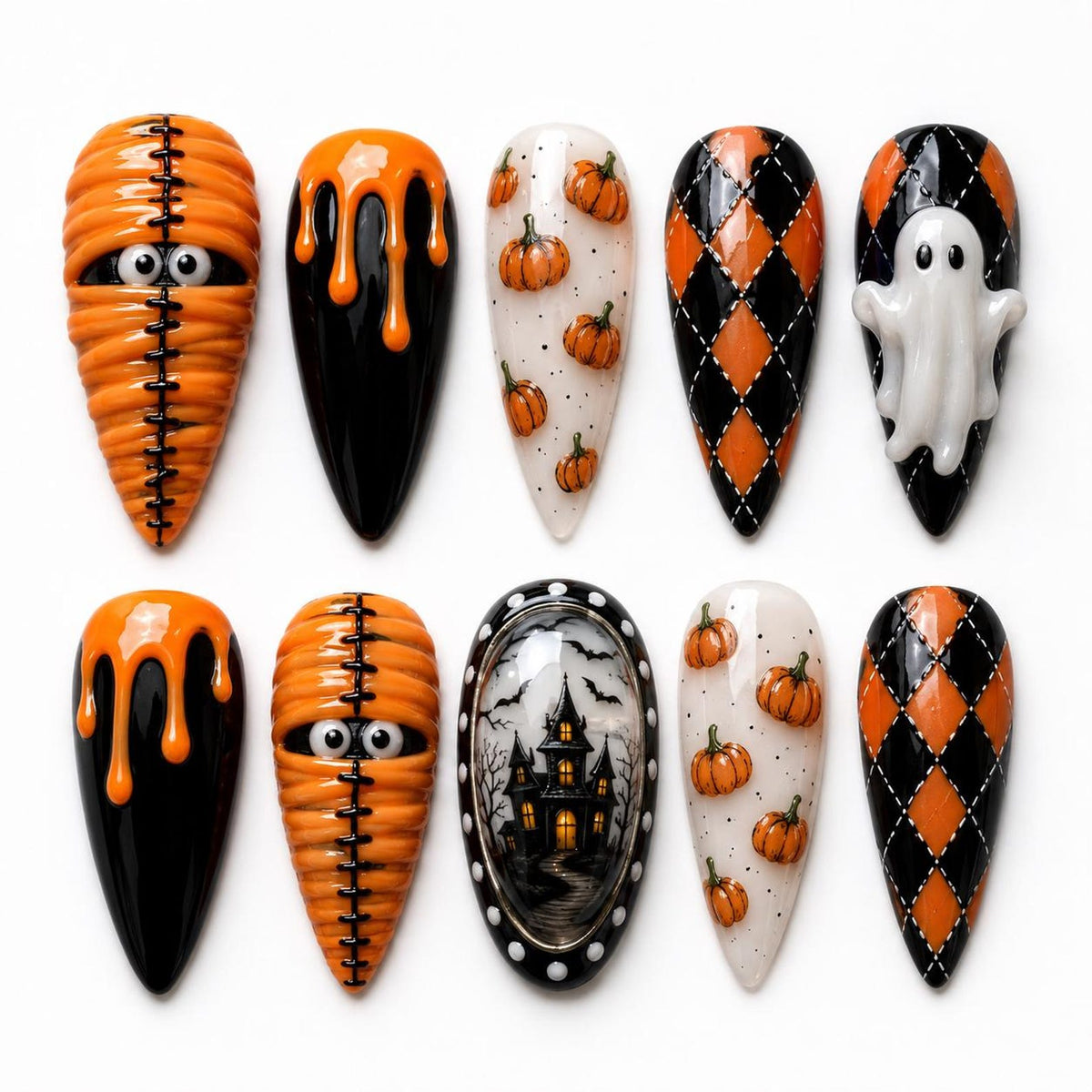 A set of ten almond-shaped press-on nails featuring Halloween designs including orange mummy wraps with eyes, black nails with orange drips, white nails with orange pumpkins, black and orange argyle patterns, a white ghost, and a haunted house.