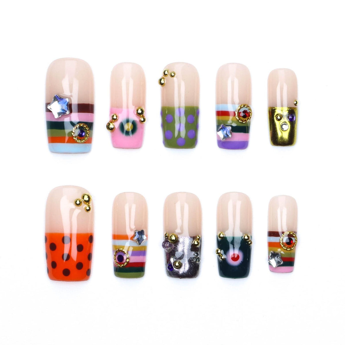 A set of ten press-on nails featuring a nude base with various decorative elements including horizontal stripes, polka dots, metallic gold accents, small colorful rhinestones, and star-shaped charms arranged in two rows of five.