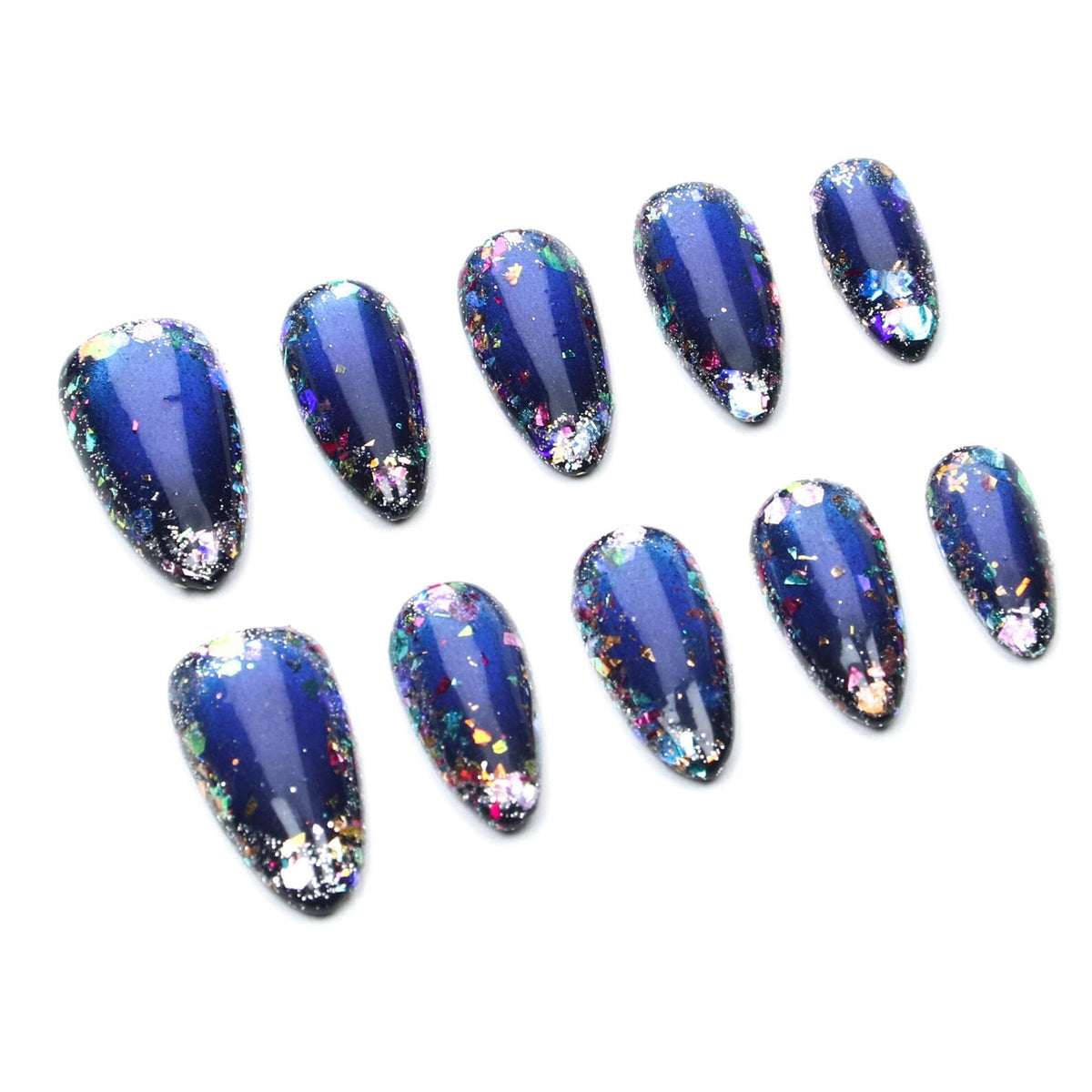 A set of ten almond-shaped press-on nails featuring a deep navy blue base color. Each nail is decorated with multi-colored iridescent foil flakes and glitter particles that create a reflective, galaxy-like appearance across the surface.