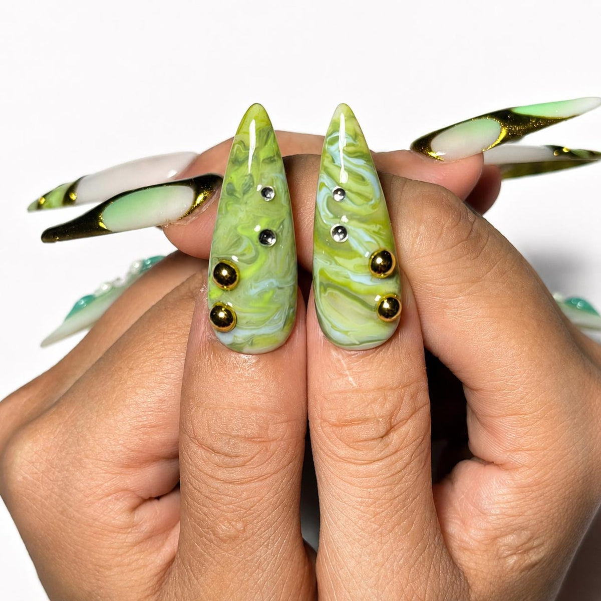 Green marble press on nails with botanical leaf art, 3D white flowers, gold chrome accents, pearl embellishments, and glossy square shape