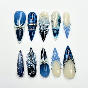 Handmade blue ocean press on nails featuring jellyfish-inspired 3D nail art, starfish accents, ocean marble effects, blue aura gradients, chrome detailing, mermaid aesthetic, and luxury reusable gel nails.