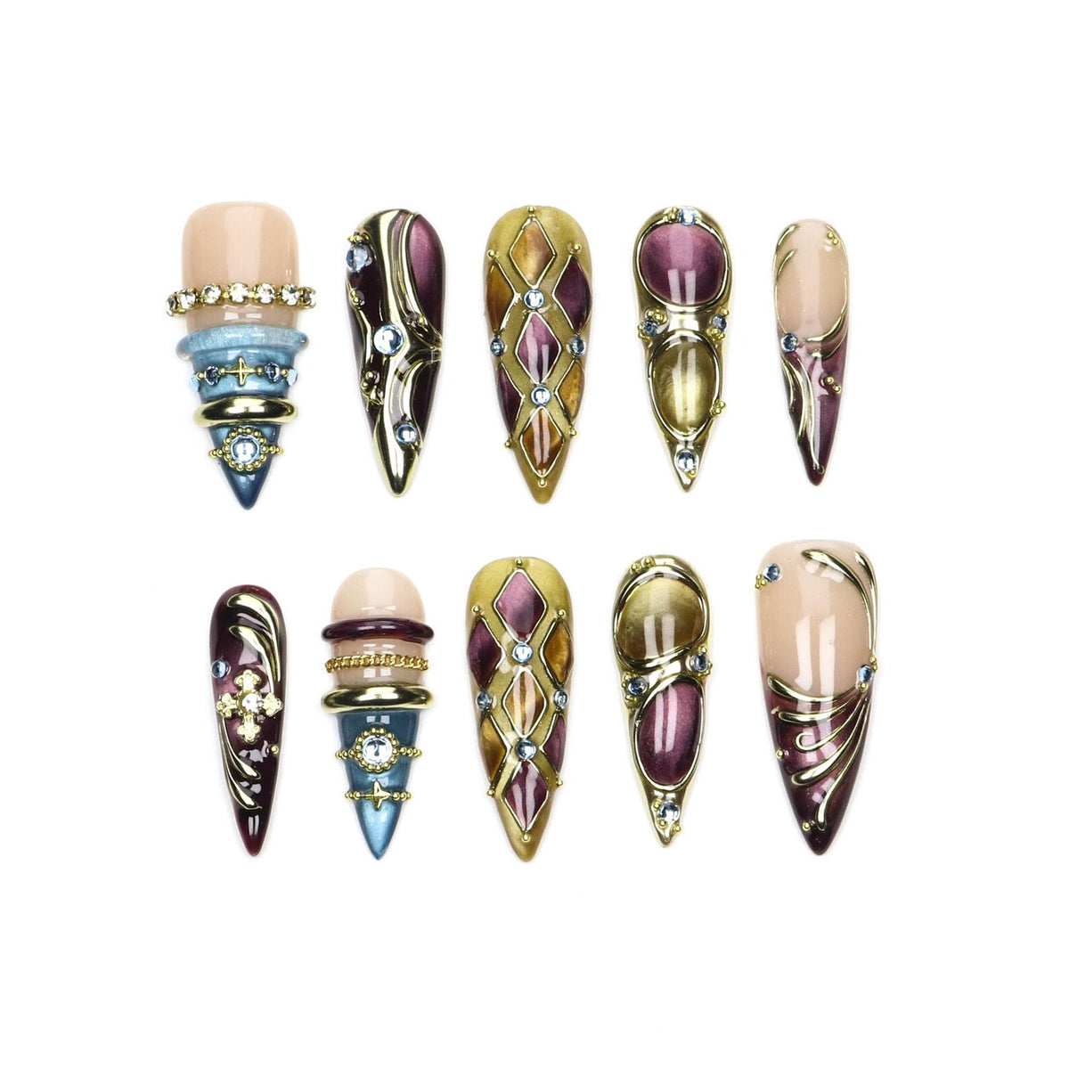 A set of ten press-on nails featuring pointed tips, decorated with gold accents, purple and blue enamel, and embedded rhinestones. The designs include geometric diamond patterns, layered ring-like bands, and ornate metallic swirls.