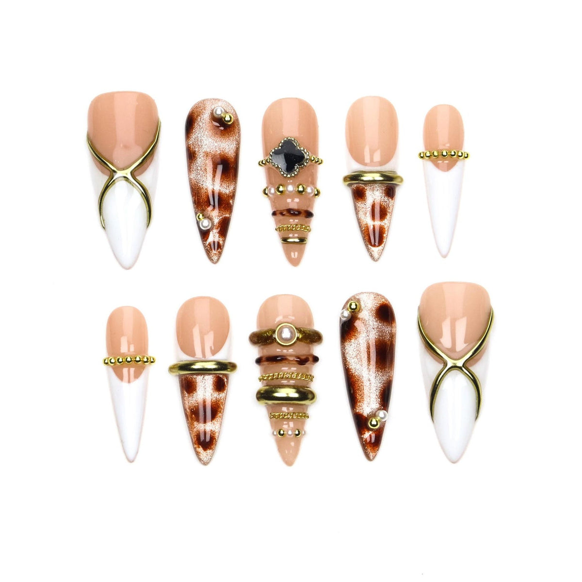 A set of ten stiletto-shaped press-on nails featuring a mix of nude and white bases. Designs include gold cross-over accents, brown leopard print patterns, small white pearls, gold beads, and a black clover-shaped charm on a nude nail.