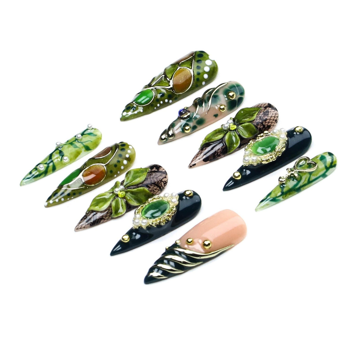 A set of ten stiletto-shaped press-on nails featuring various designs in shades of green, black, and peach. The nails are decorated with three-dimensional floral elements, gold metallic accents, faux pearls, and intricate lace patterns.