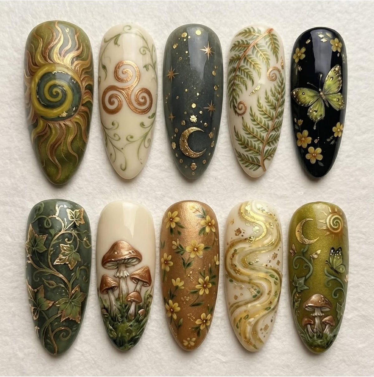 Ten almond-shaped press-on nails featuring intricate hand-painted designs including a golden sun, a triskele, a crescent moon with stars, green fern leaves, a butterfly with flowers, ivy vines, mushrooms, yellow flowers, and swirls.