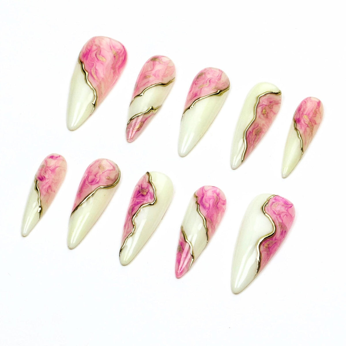 A set of ten almond-shaped press-on nails featuring a split design. Each nail has a creamy off-white base on one side and a swirling pink and white marble pattern on the other, separated by a thin, raised metallic gold line.