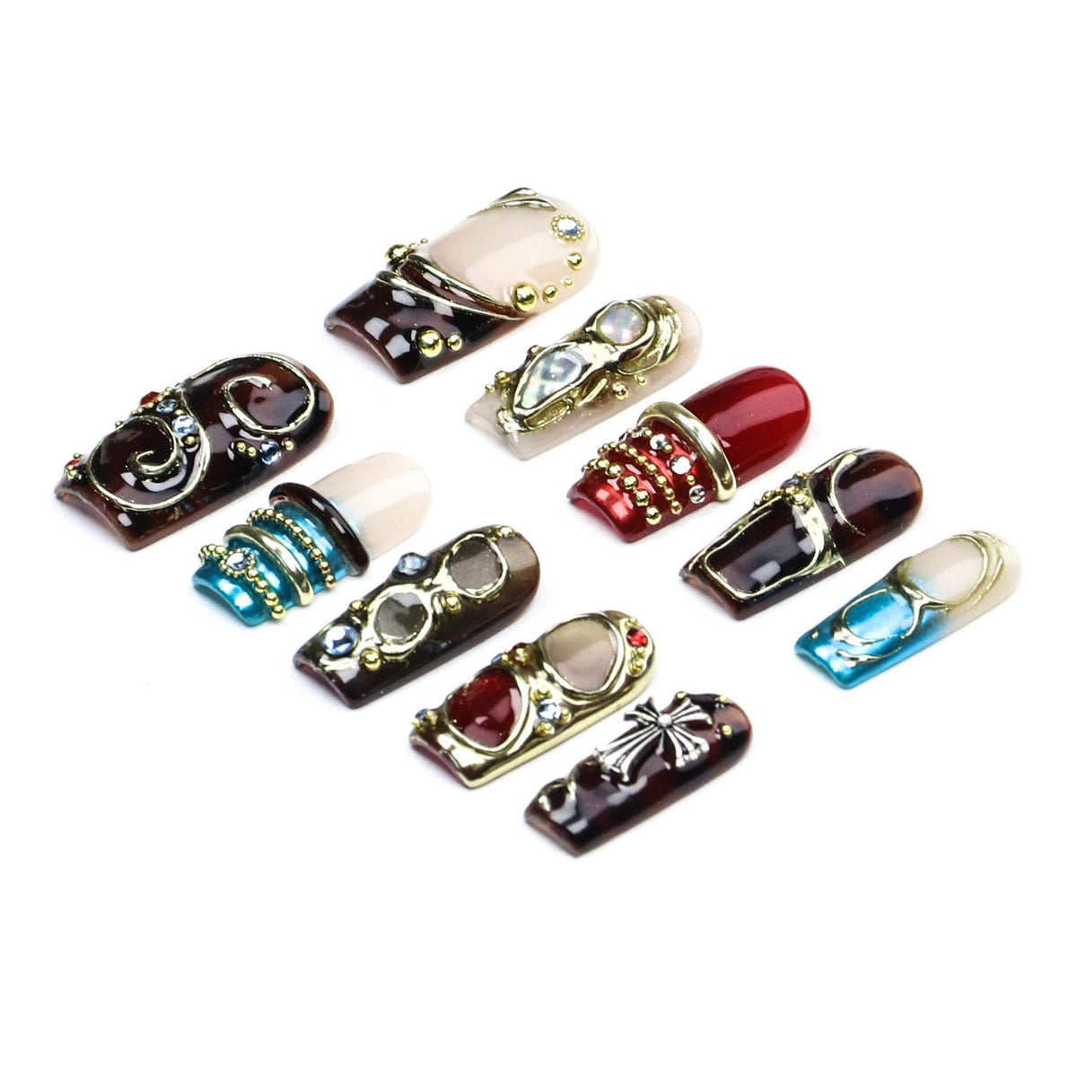 A collection of ten press-on nails featuring diverse designs including deep brown, red, and blue tones. The nails are decorated with gold-toned metal accents, small rhinestones, and a silver-colored cross emblem on a dark brown base.