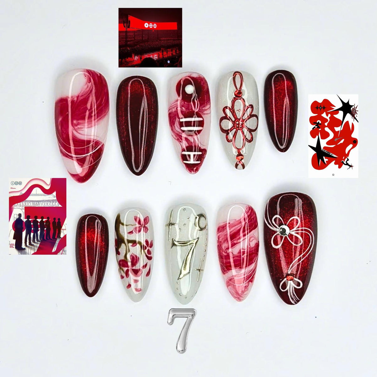 A set of ten almond-shaped press-on nails featuring a red and white color palette. Designs include red marble swirls, deep red glitter, a red decorative knot, a cherry blossom branch, a silver number seven, and small rhinestones.