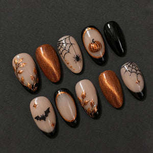 A set of ten almond-shaped press-on nails featuring a Halloween theme. Designs include metallic copper pumpkins, black spiderwebs with spiders, black bats, and gold leaf foliage on nude and solid copper glitter backgrounds.