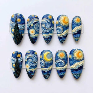 A set of ten almond-shaped press-on nails featuring a hand-painted design inspired by The Starry Night. The nails display swirling blue and yellow brushstrokes, a dark cypress tree, a crescent moon, and a small village landscape.