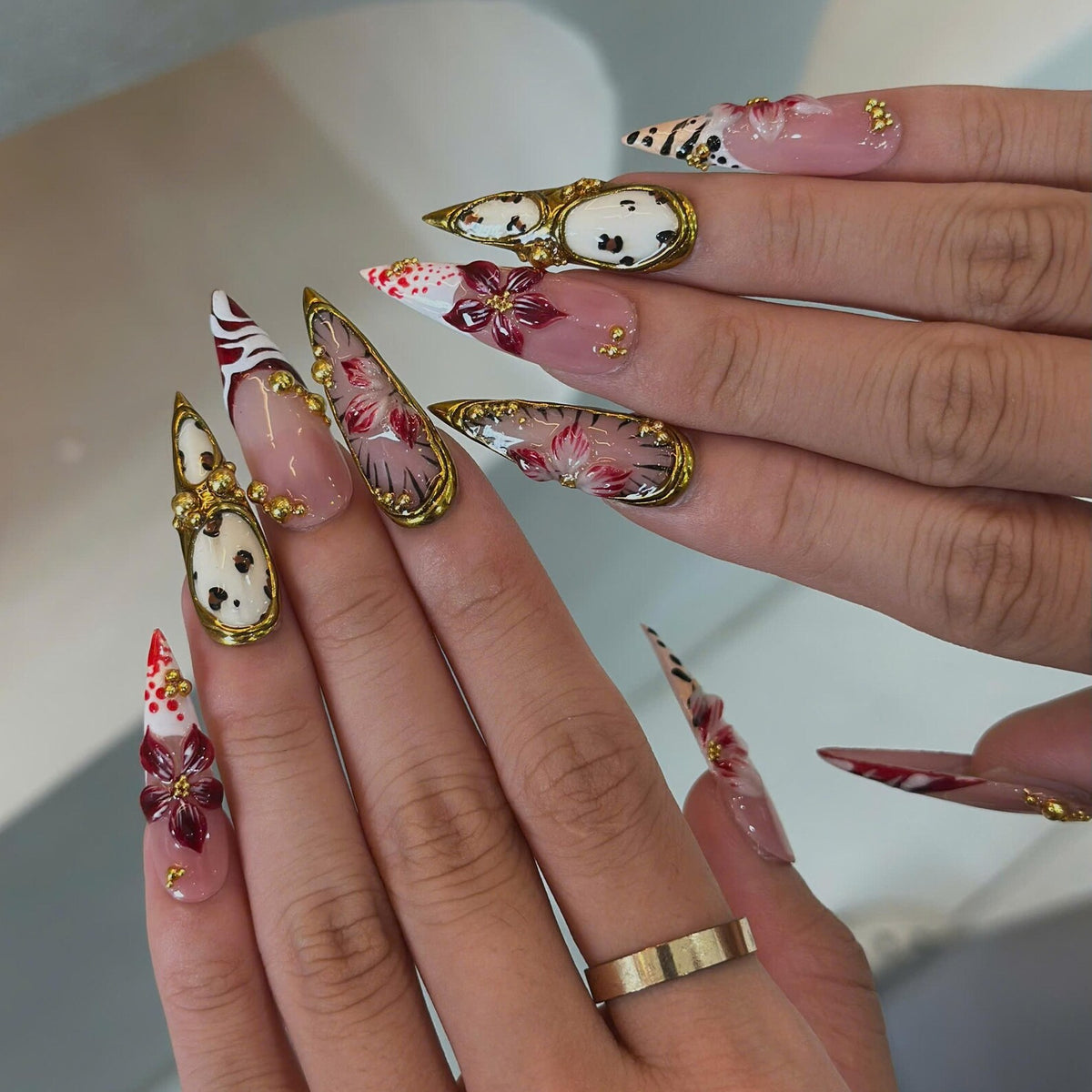 Vintage floral press on nails with blush pink and burgundy colors, 3D flowers, ornate antique gold mirror details and romantic long pointed nail art.