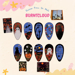 A set of ten almond-shaped press-on nails featuring Halloween-themed illustrations including ghosts, black cats, pumpkins, skulls, bats, and spiderwebs in a color palette of black, blue, orange, and white, with the text BURNTCLOUD.