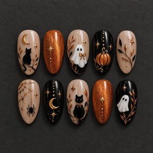 A set of ten almond-shaped press-on nails featuring Halloween-themed designs. The nails include black cats, white ghosts, orange glitter, gold crescent moons, stars, spiderwebs, spiders, pumpkins, and gold leaf branch accents on black and nude bases.